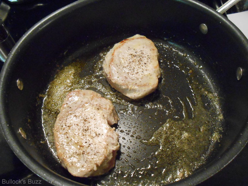 browning pork chops in a large skillet