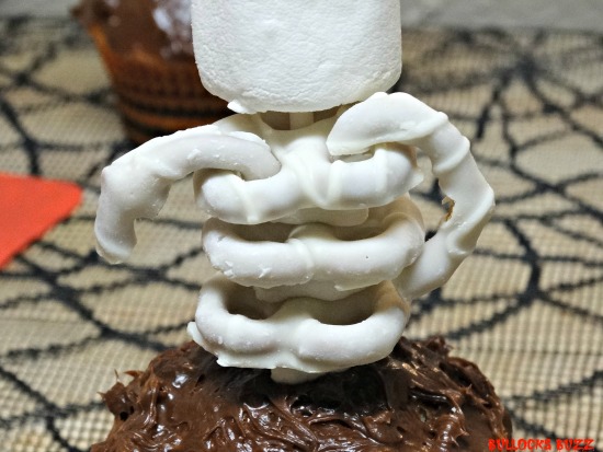 Last Minute Halloween Party Treats Scary Skeleton Cupcakes use icing to attach pretzel arms