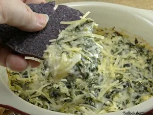 chip dipped in Spinach and artichoke dip