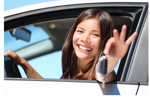 teenage driver holding keys and smiling
