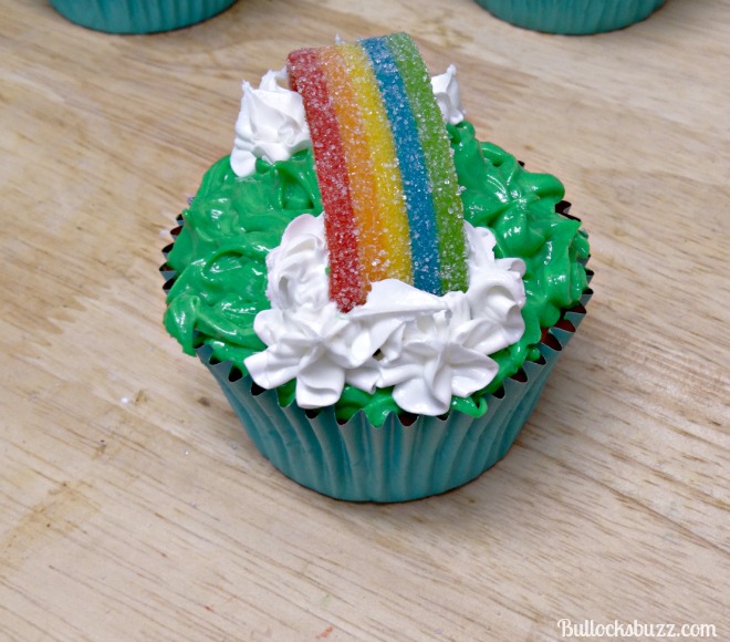 Pot O' Gold Cupcakes add white icing clouds