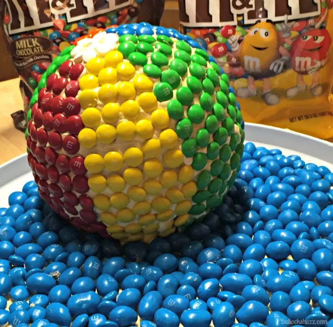 beach ball cake on tray in front of M&MS bags