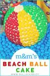 A beach ball cake covered in colorful M&Ms. A fun cake perfect for beach themed parties!