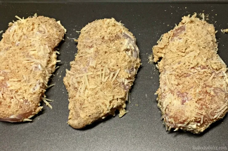 Roasted Garlic Ranch and Shredded Parmesan Baked Chicken lay chicken on baking sheet