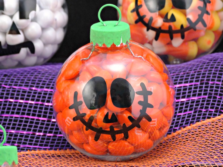 DIY Halloween candy ornaments pumpkin filled with orange candy.