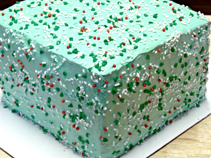 add the sprinkles to the top and sides of the surprise inside cake  
