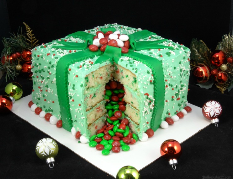 A Christmas Cake designed to look like a gift with candy in the inside.