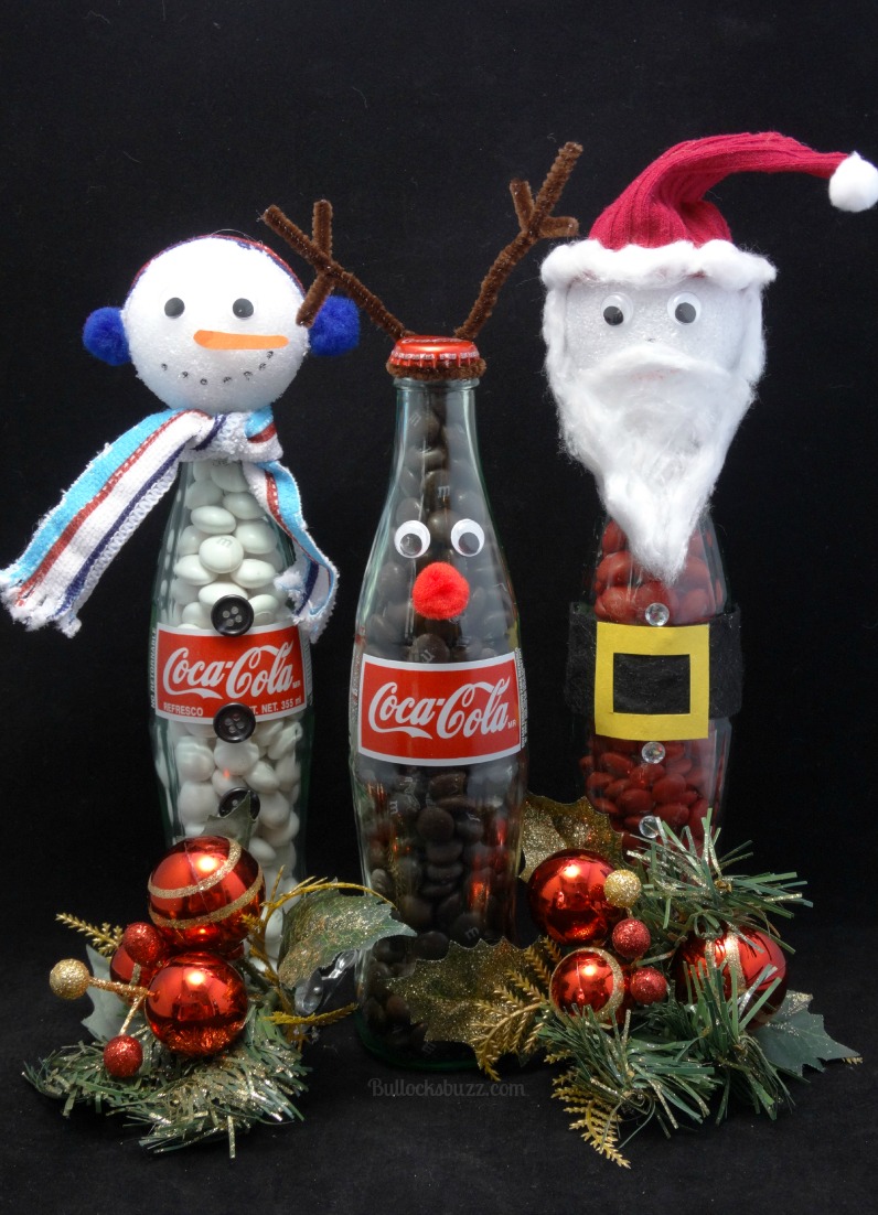 These adorable DIY Coke Bottle Christmas Characters are a great way to upcycle your old bottles after you've made Coca Cola Christmas Cupcakes! Perfect for decor, parties or unique gifts! #Christmascrafts #upcycledChristmascraft #Christmas #crafts