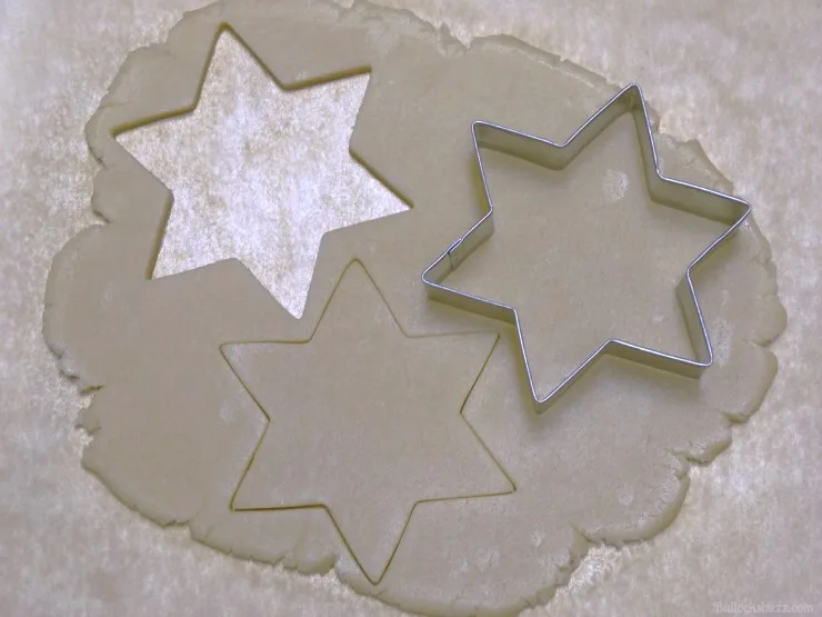 use cookie cutters to cut out cookies from dough