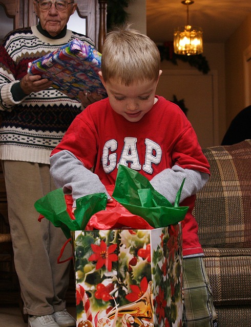 the essential guide to buying children's gifts this christmas kid opening gift image