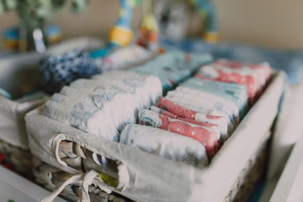 A basket full of diapers highlighting the need for finding ways to save on diapers