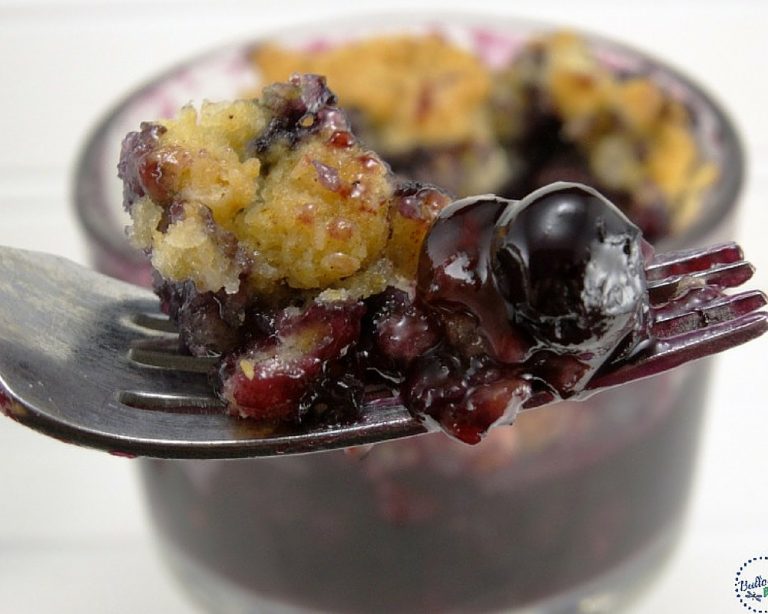 closeup of a bite of blueberry cobbler on a fork