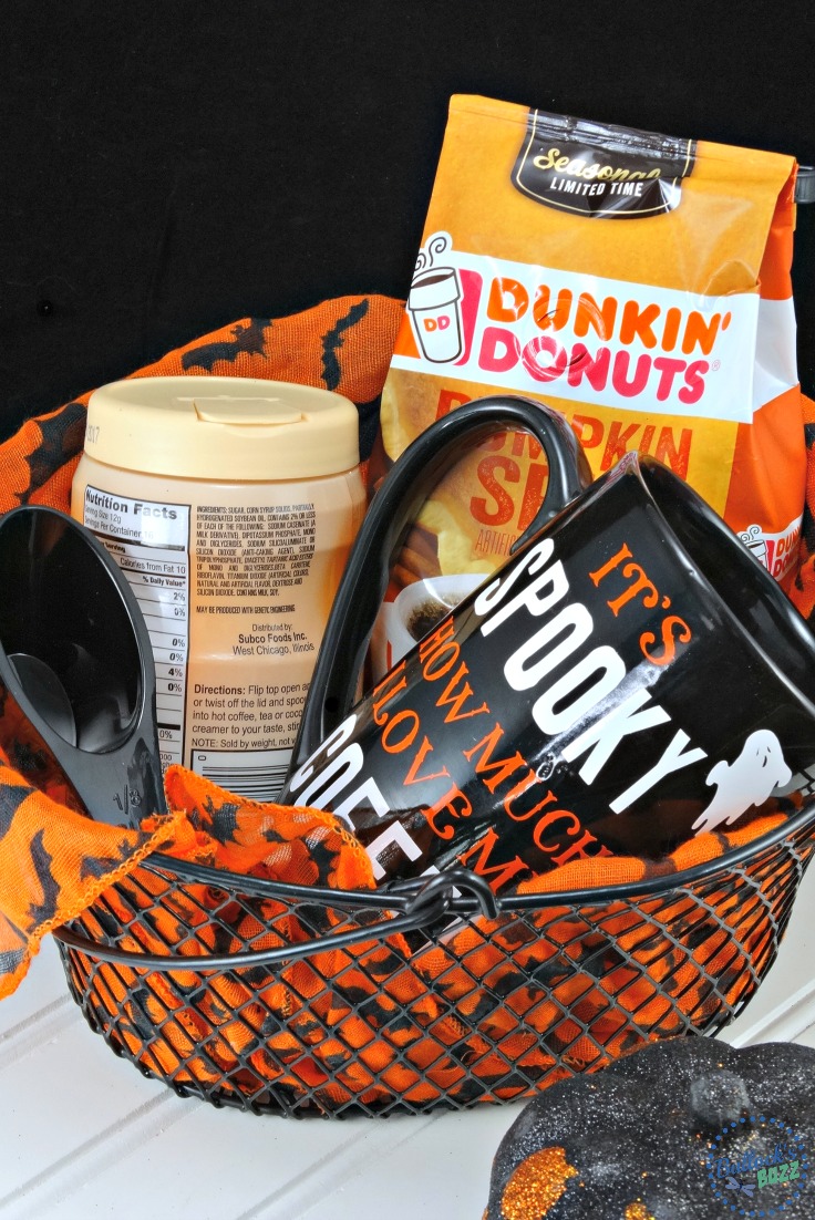 DIY halloween coffee mug along with some Dunkin Donuts coffee and creamer in a gift basket