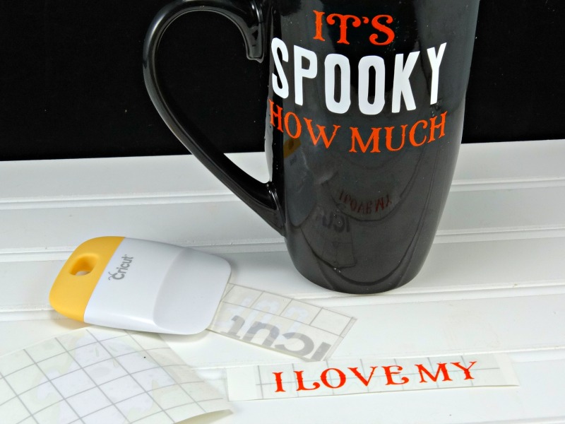 begin adding vinyl to the DIY Halloween coffee mug smoothing as you go