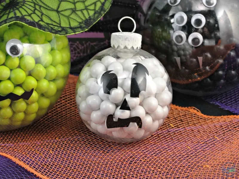 Ornament filled with white candies and decorated to look like a ghost