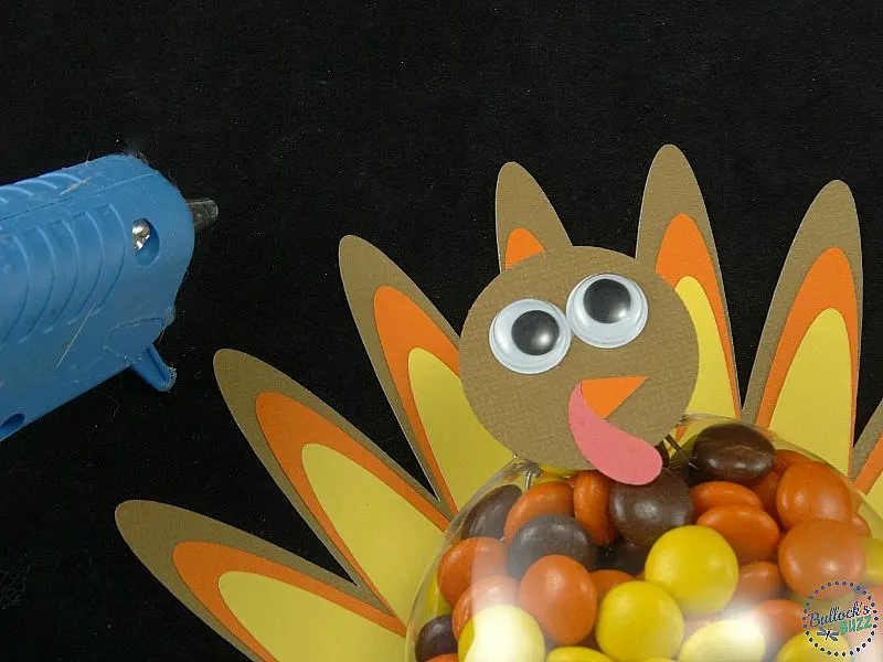 glue head to front of ornament cap then add eyes, beak and snood to make face of the DIY Thanksgiving Turkey Treats