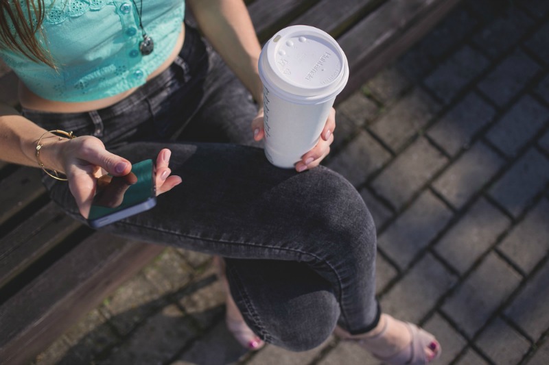 these branding tips can help you create a coffee cup that promotes your brand like this one this woman is holding