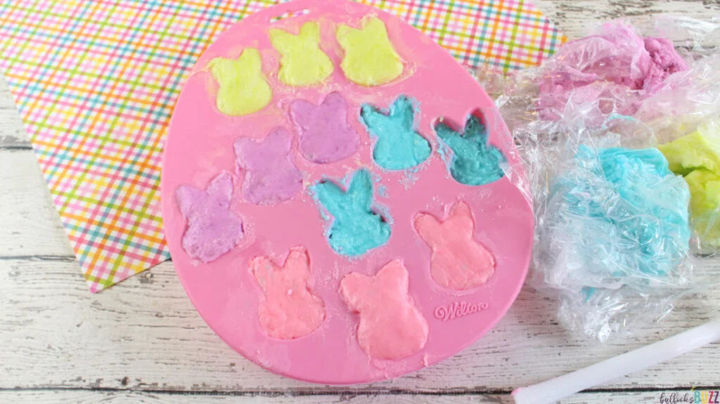 A silicone bunny mold with different colored dough pressed into each well