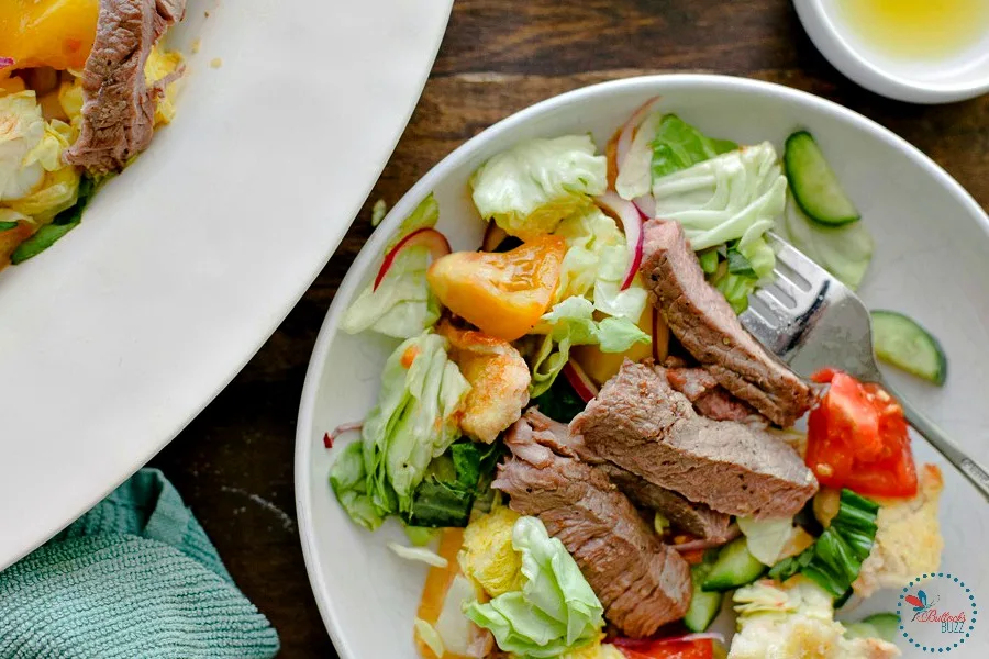 Chunks of bread and heirloom tomatoes soak in a zesty dressing, while tender grilled steak adds a delicious twist to this classic Italian salad, Panzanella.