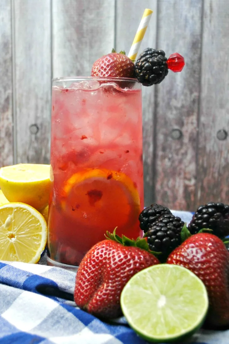 Close up of cocktail. A simple, yet refreshing adult-only lemonade made with a splash of fresh squeezed lemon and lime, fresh berries and then topped off with Rum and Vodka. This Berry Smash Lemonade is a fruity concoction that's sure to be a smash hit!