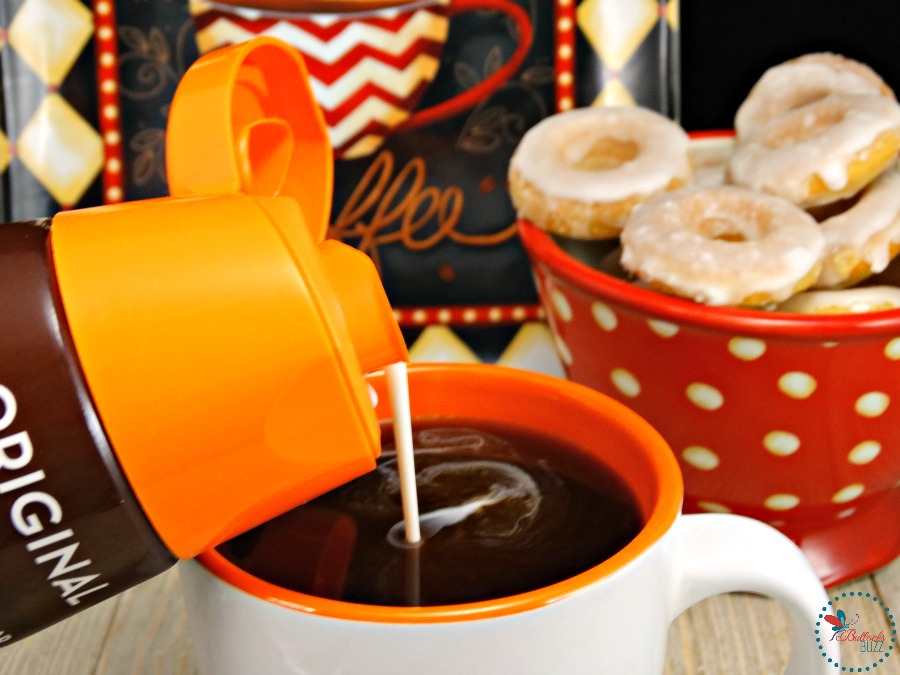 pouring creamer in cup of coffee