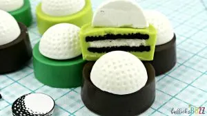 Golf Ball Cookies stacked with a cut-open Oreo cookie showing the chocolate layers and white golf ball topping