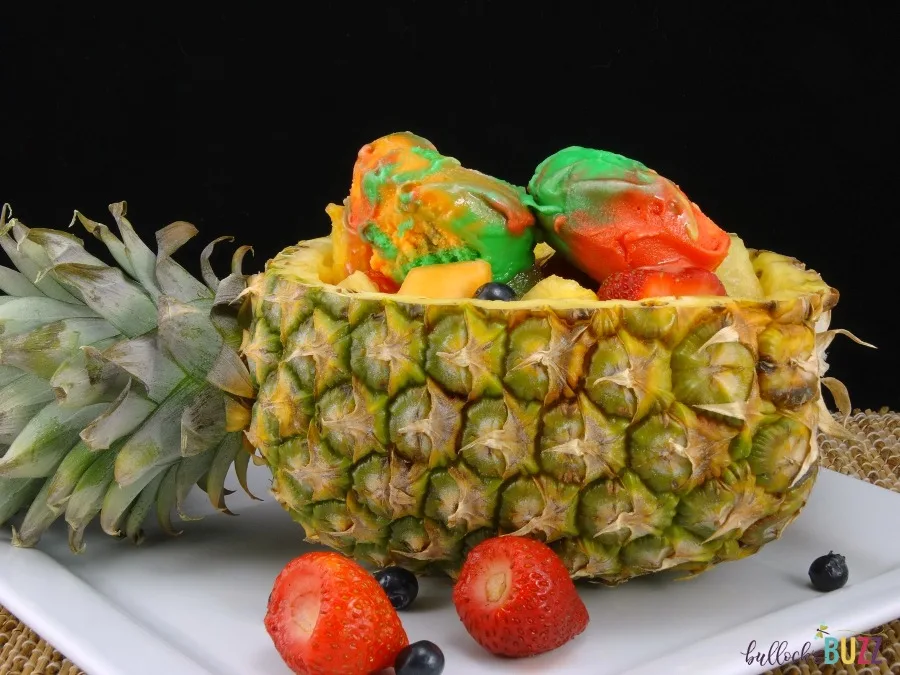 Served in a pineapple boat, fresh fruit is tossed together then topped with a few scoops of your favorite flavor sherbet in this deliciously refreshing Pineapple Boat Fruit Salad recipe.