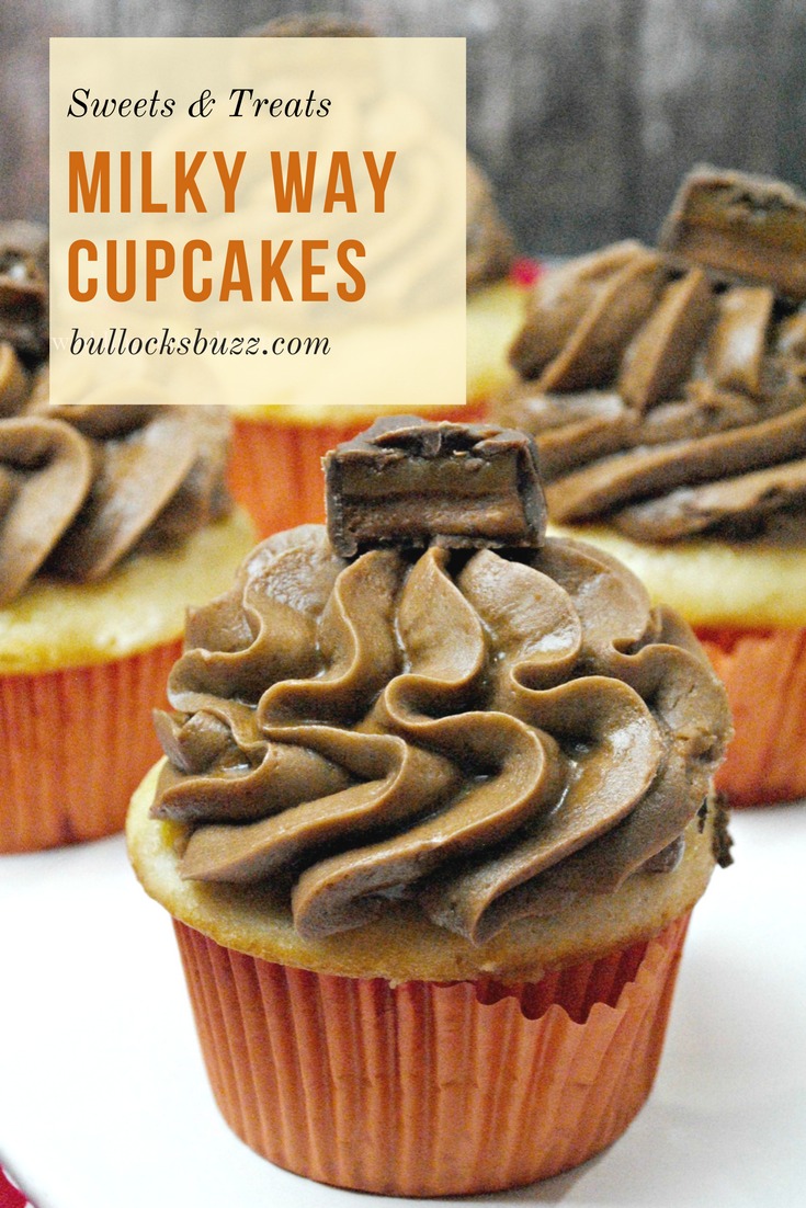 Heavenly caramel-vanilla cupcakes are topped with a rich, creamy, chocolate-caramel frosting and then crowned with a piece of a Milky Way candy bar in these otherworldly Milky Way Cupcakes. #cupcakes