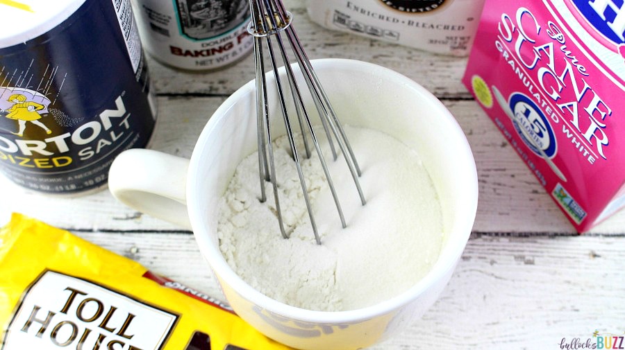 S'mores Mug Cake begin by adding flour, baking powder, salt and sugar to mug