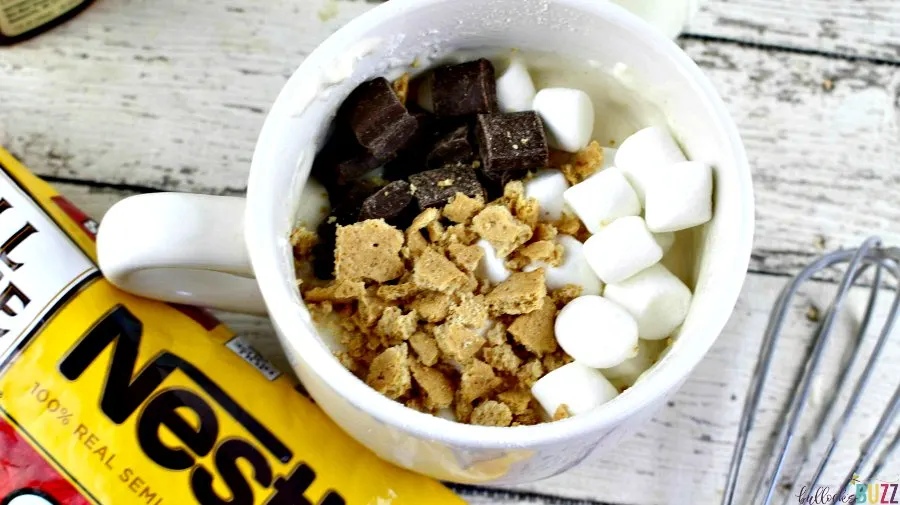 Add marshmallow, chocolate and crackers stirring to combine for a S'mores Mug Cake