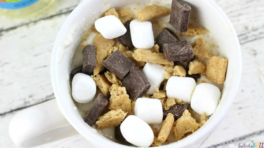 Top the S'mores Mug Cake with remaining marshmallow, chocolate and crackers