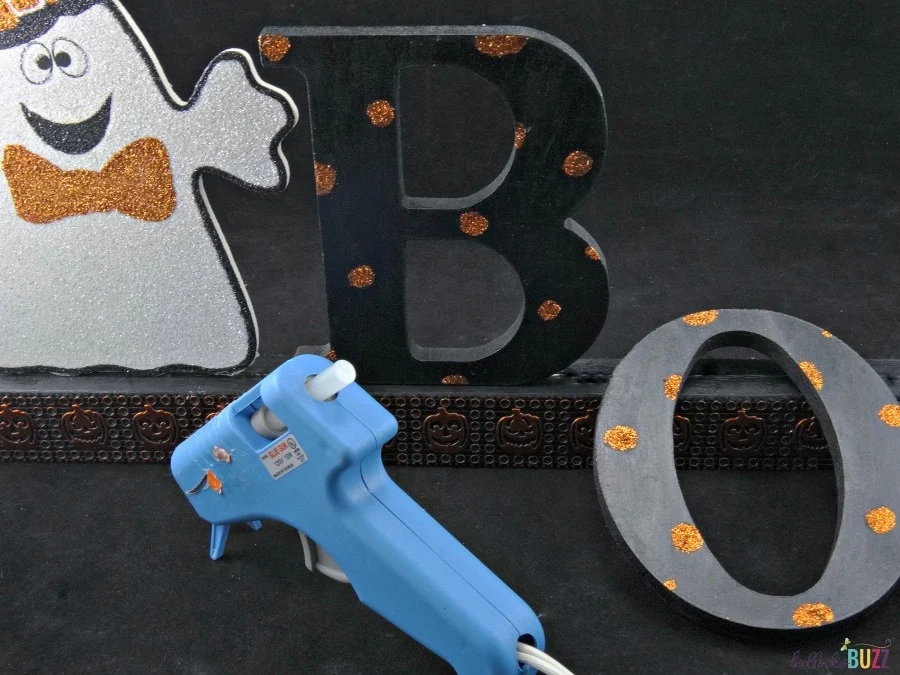 Attach the ghost and letters using hot glue or wood glue to the DIY Halloween sign