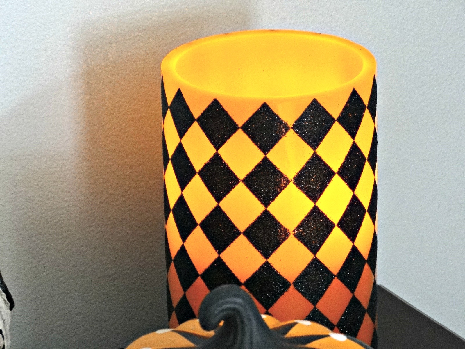 Haunted Harlequin LED black and orange checkered glitter candle