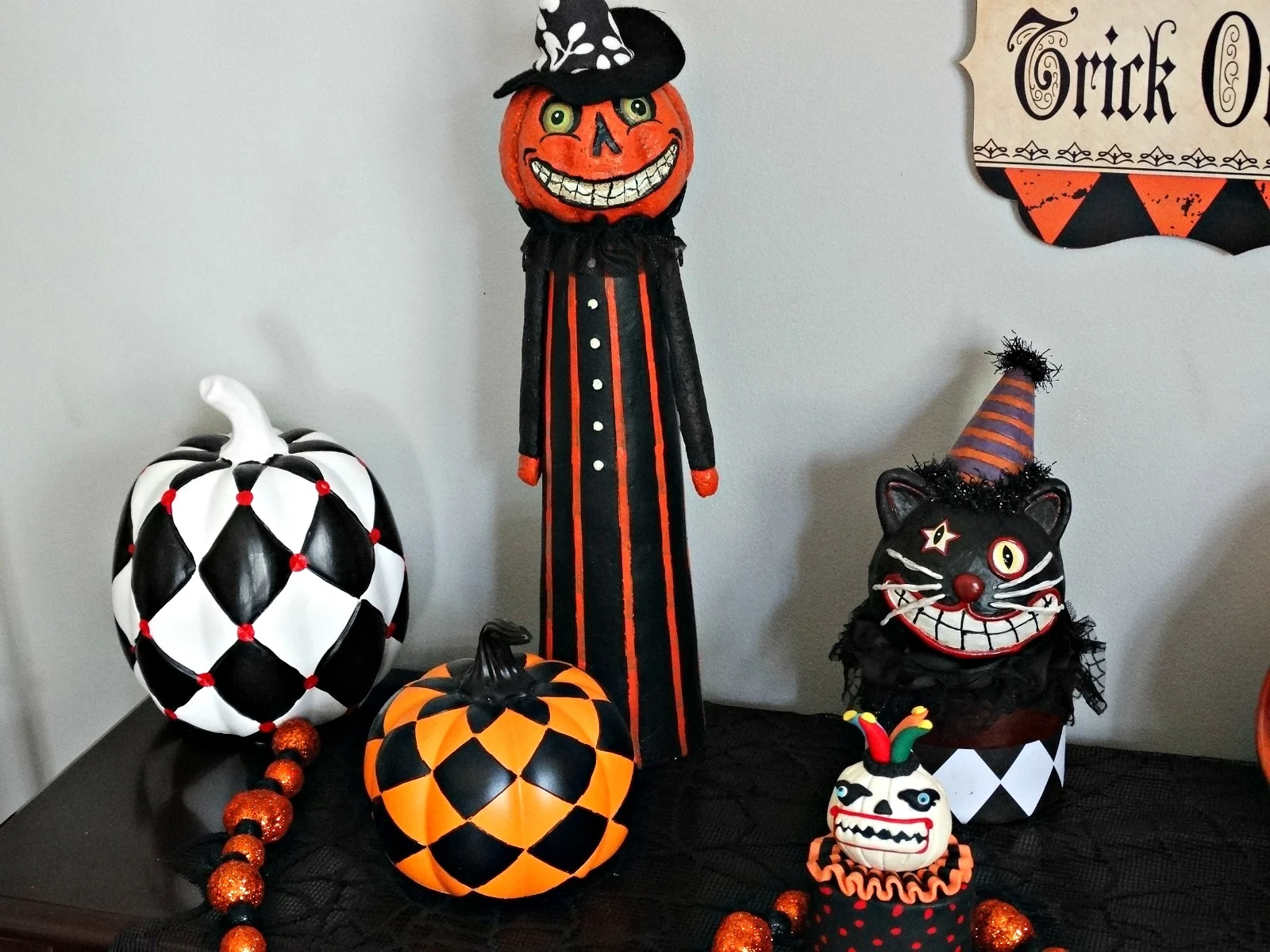 Haunted Harlequin tablescape checkered pumpkins and figurines