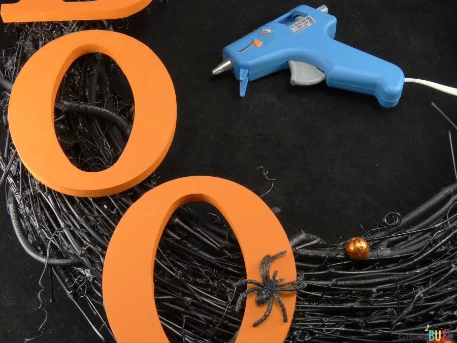 DIY Halloween Wreath tutorial use hot glue to attach letters to wreath