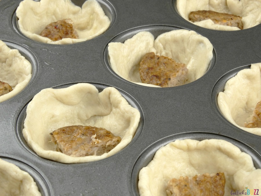 Place a quarter of sausage patty in each biscuit cup for Sausage, Egg and Herbed Cheese Breakfast Muffins