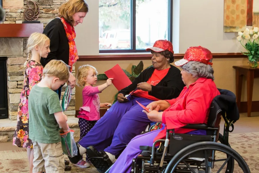 family volunteer day giving cards to elderly