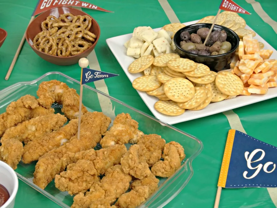 tailgating appetizers with chicken crackers and cheeses