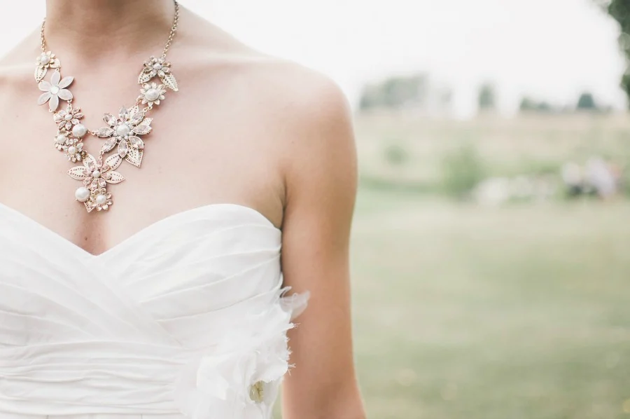 A bride wearing a beautiful dress and necklace