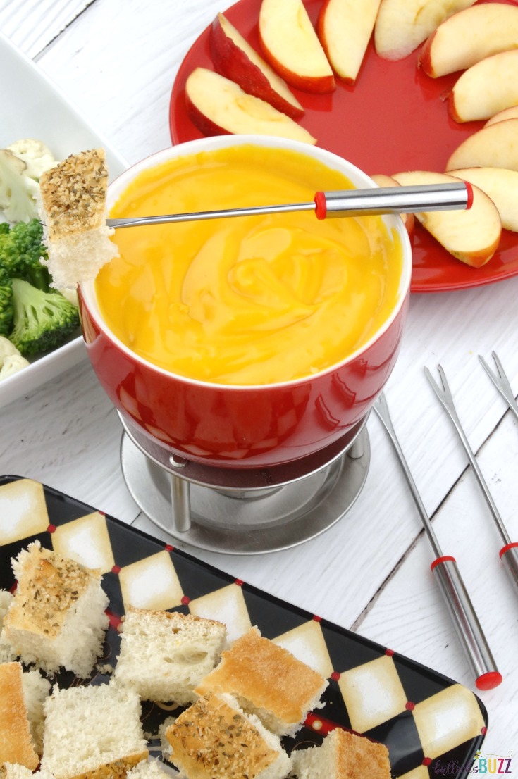A deliciously easy, smooth and creamy Cheddar Cheese Fondue recipe that goes perfectly with fruits, veggies, meat and bread!
