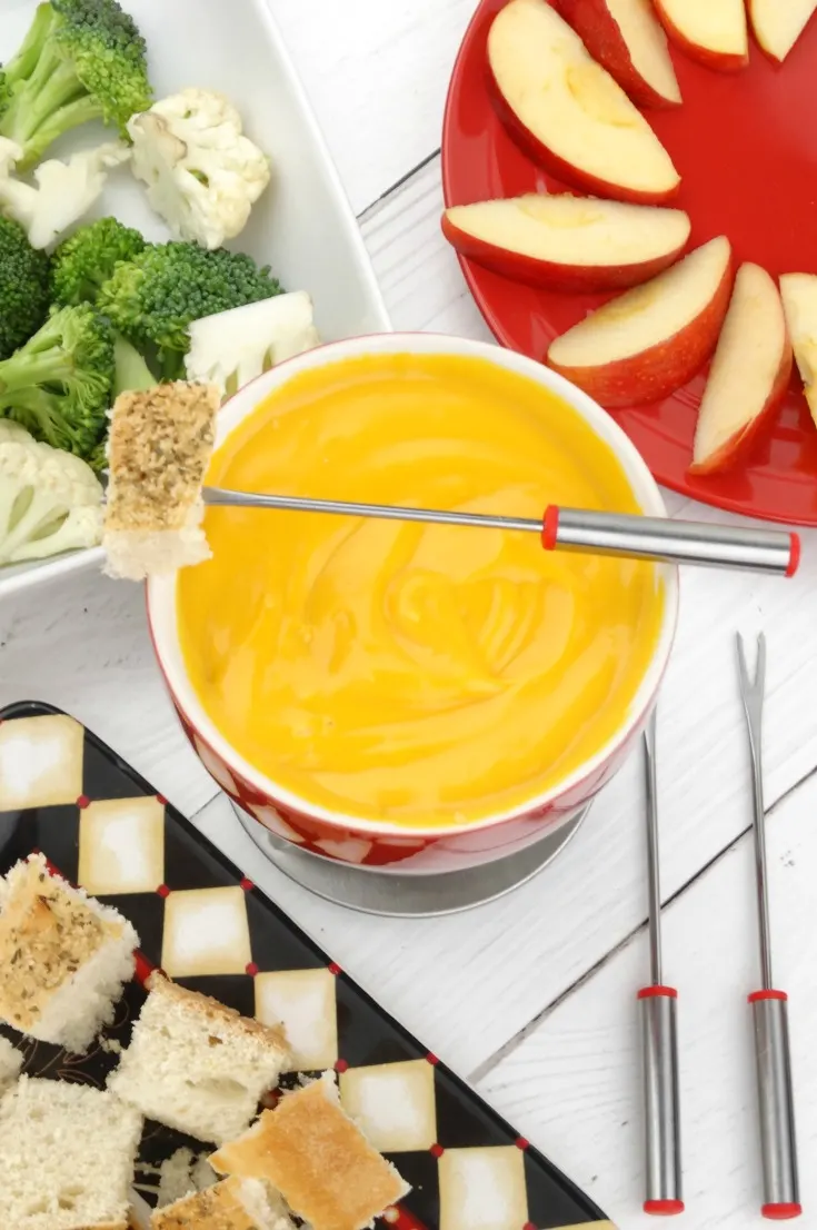This smooth and creamy Cheddar Cheese Fondue is an easy cheese fondue recipe that's perfect as an after school snack, for a romantic dinner for two, or for a fun fondue party with family and friends!
