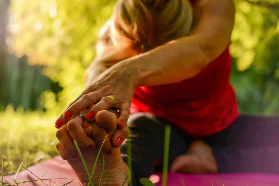 low impact stretching liek the woman in this picture could help with injury prevention in older adults