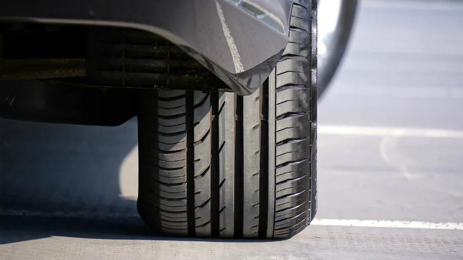 inspecting car tires - check the tread