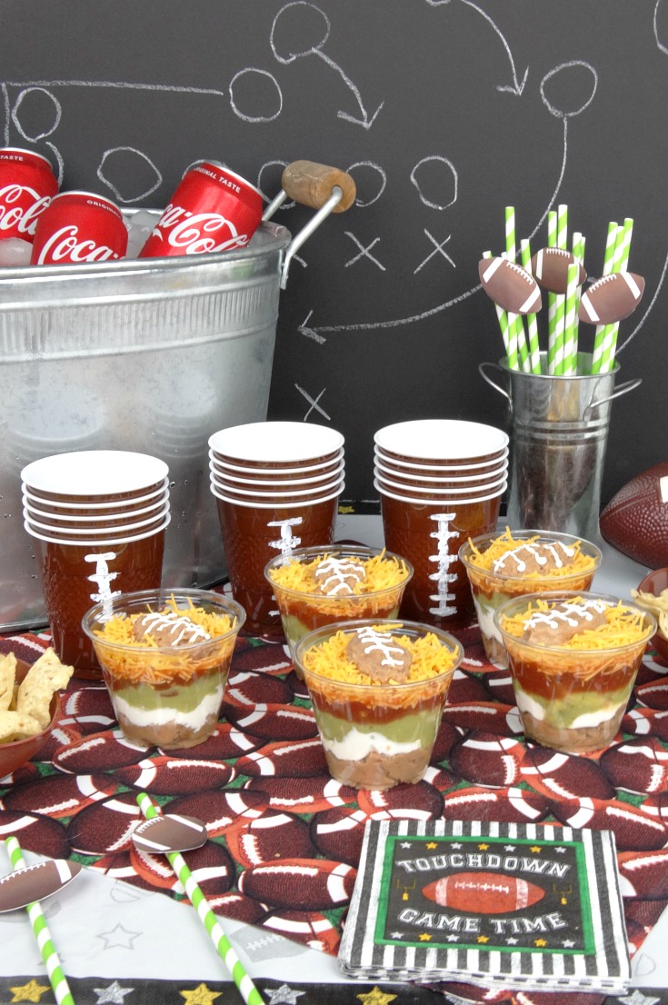 Make your next homegating party a big win with this recipe for Individual Five Layer Football Party Dip Cups, plus free printable football straw toppers!