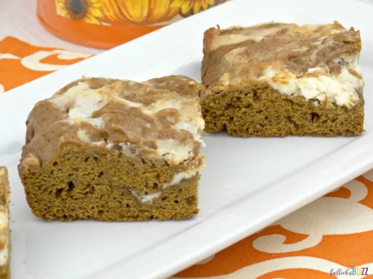 Moist and delicious, these Swirled Pumpkin Spice Bars with Cream Cheese Frosting recipe