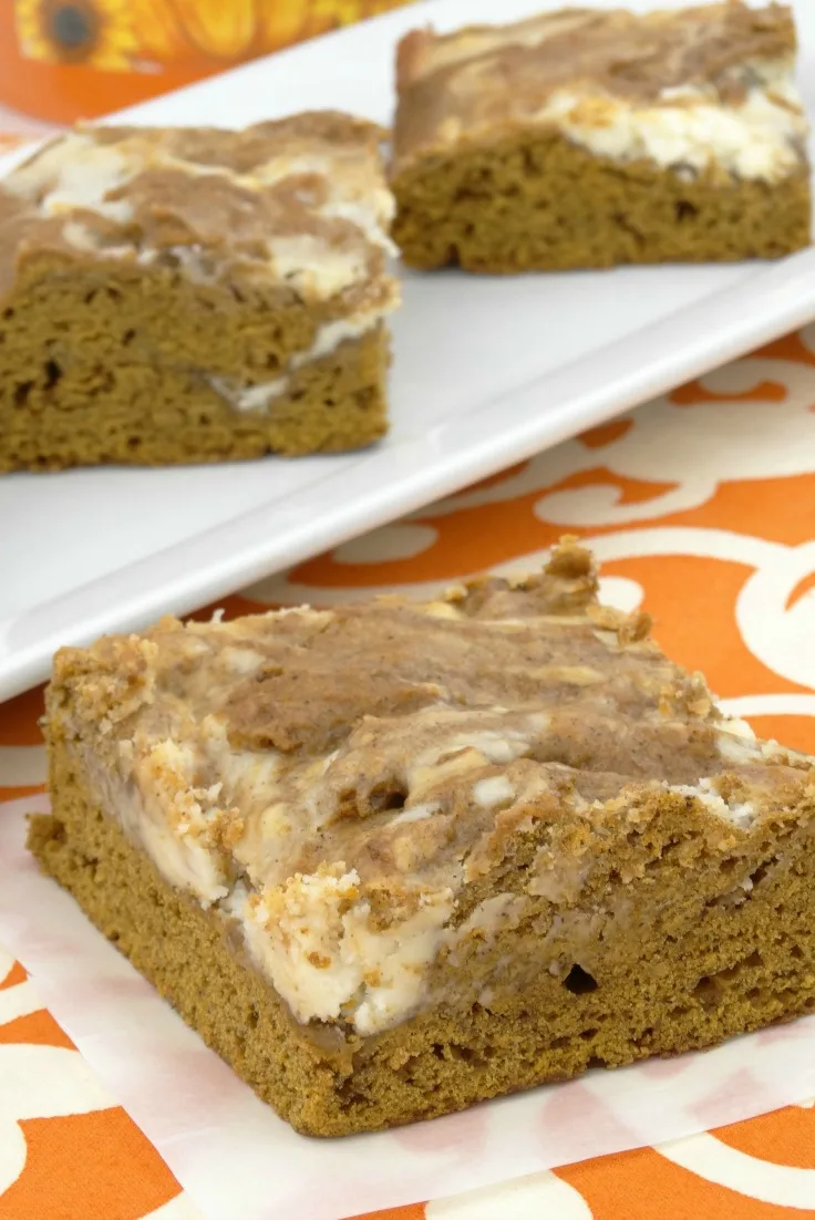 homemade Swirled Pumpkin Spice Bars with cream cheese frosting