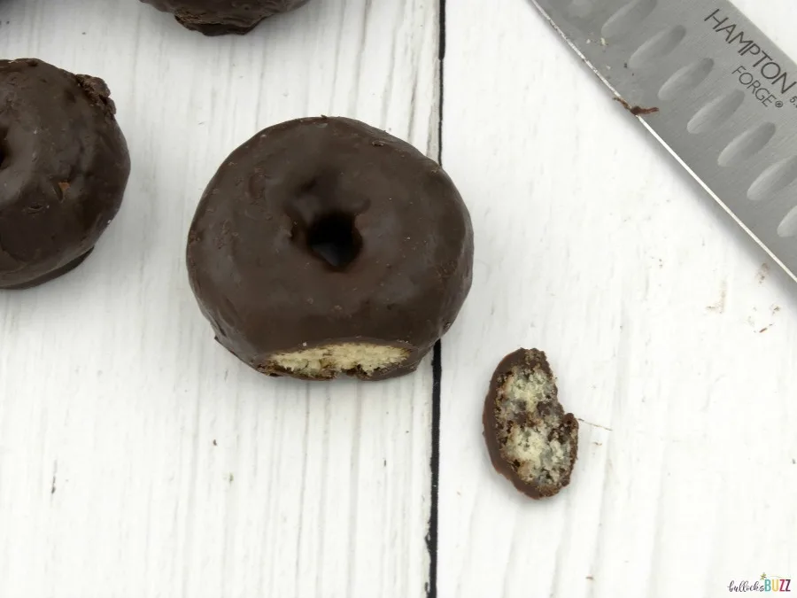 Use a bread knife to carefully slice the bottom edge of the donut off so it has a flat edge to stand up on.