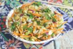 finshed thai chicken salad in bowl with chopsticks