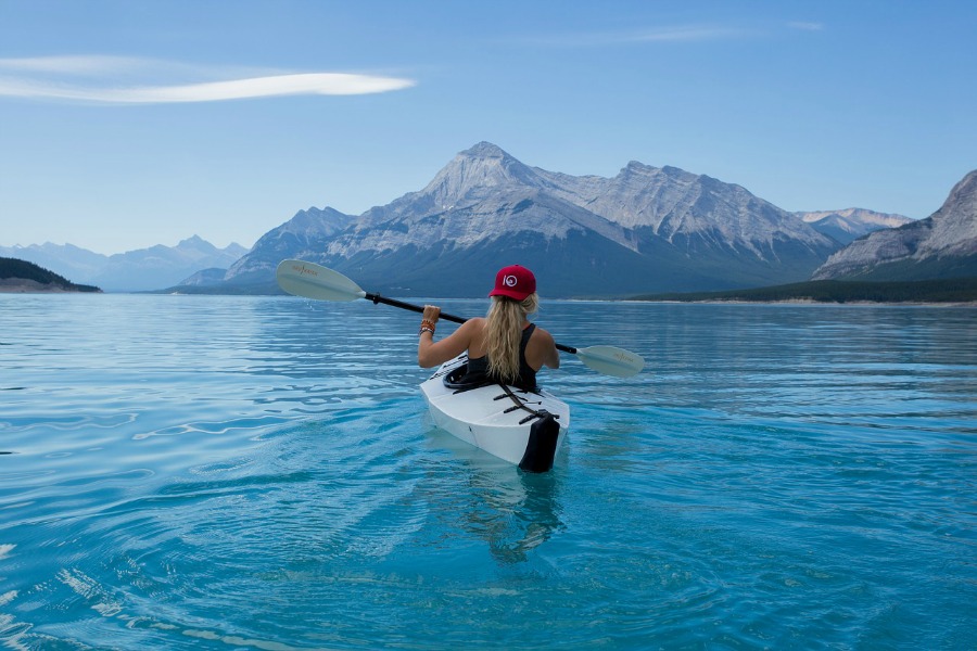 kayaking in lake surrounded by mountains