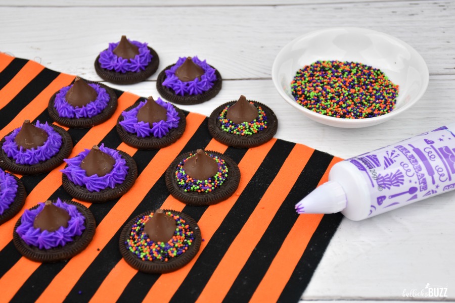 decorate with hats with purple icing and Halloween sprinkles